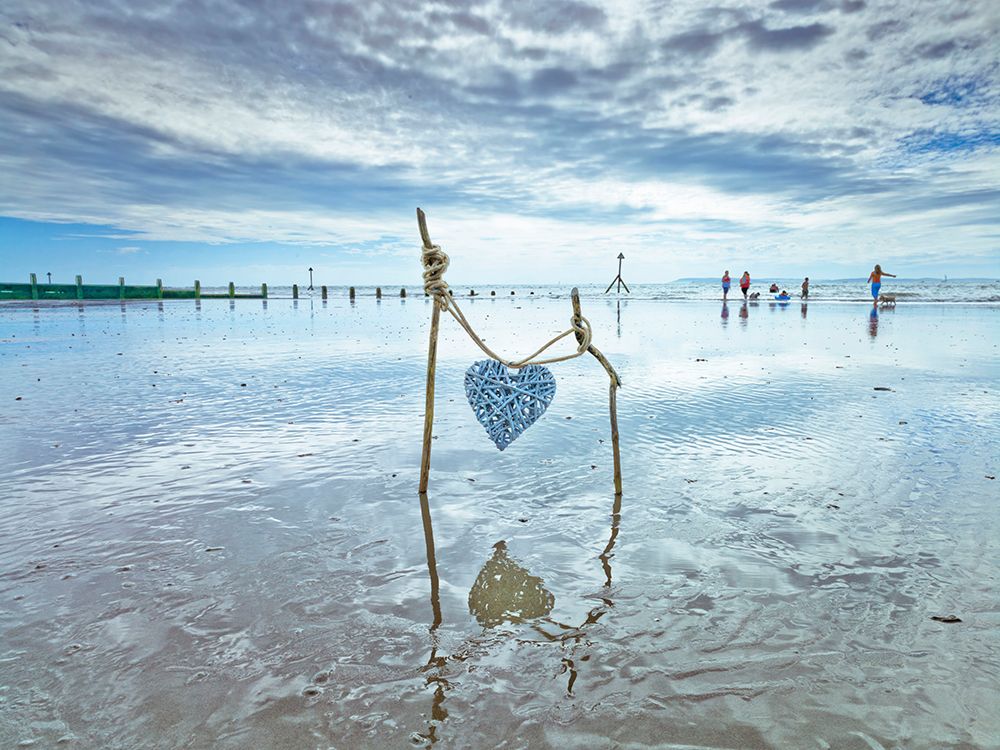 Heart tied up on wooden sticks at the beach art print by Assaf Frank for $57.95 CAD