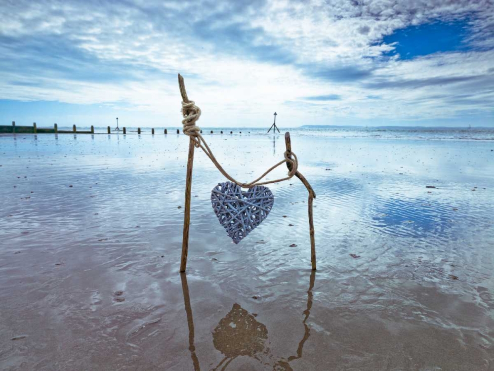 Heart tied up on wooden sticks at the beach art print by Assaf Frank for $57.95 CAD