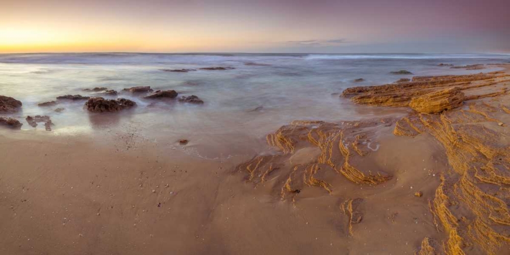Sunset on rocky beach with colorful sky art print by Assaf Frank for $57.95 CAD