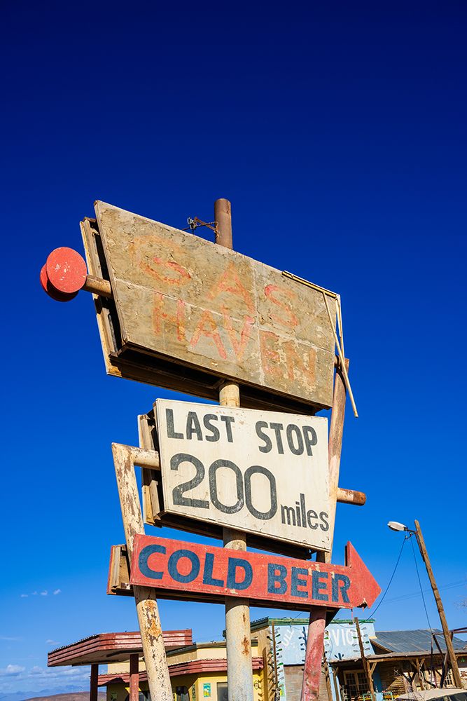 Rusty Road Sign For A Tavern And Cold Beer In A Desert Area. Ouarzazate, Morocco art print by Alberto Biscaro for $57.95 CAD