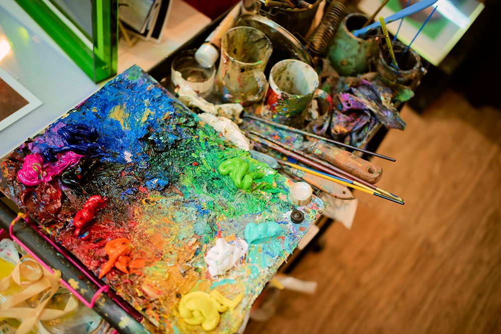 Colorful Painters Palette With Brushes And Mixed Vibrant Paints In An Art Studio. Shanghai, China art print by LB Studios for $57.95 CAD