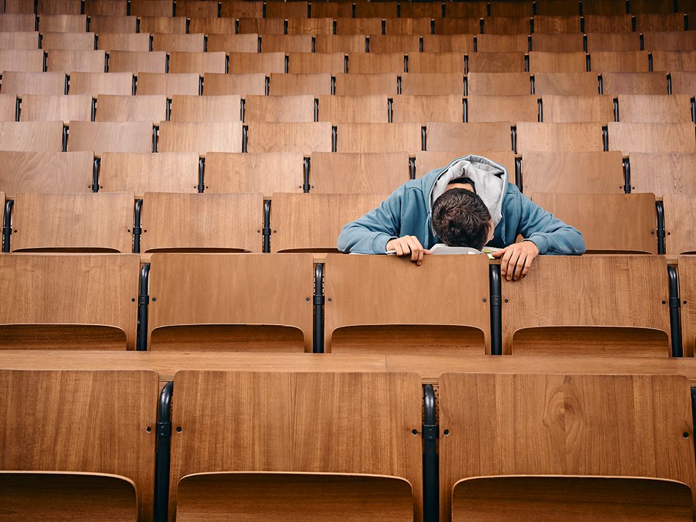 Alone Student Sleeps On Desk In Empty Lecture Hall With Wooden Seats. Germany art print by Markus Moellenberg for $57.95 CAD