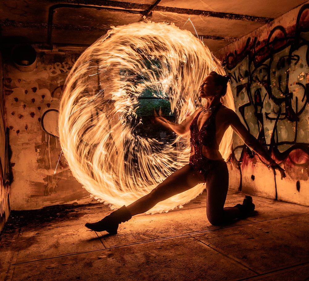 Woman Performing Fire Spinning In A Graffiti-Covered Urban Setting. Wa, USA art print by Pete Saloutos for $57.95 CAD