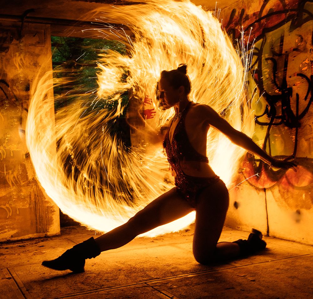Performer Twirls A Flaming Hoop In A Graffiti-Covered Urban Setting At Night. Wa, USA art print by Pete Saloutos for $57.95 CAD