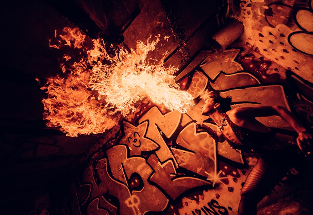 Fire Performer Breathes Flames In Front Of Vibrant Graffiti Underpass At Night. Wa, USA art print by Pete Saloutos for $57.95 CAD