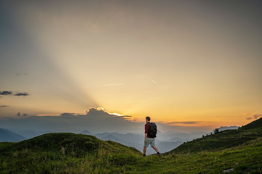 Mature Man With Backpack Walking On Mountain At Sunrise art print by Daniel Ingold for $57.95 CAD