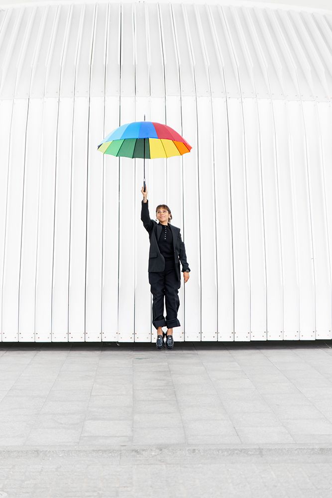Businesswoman With Colorful Umbrella In Front Of Modern Architecture art print by Pau Cardellach Lliso for $57.95 CAD