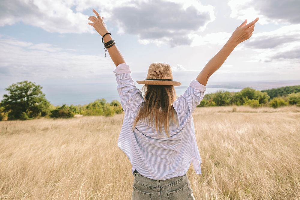 Woman With Arms Raised Enjoying Freedom In Golden Field Outdoors art print by Svetlana Iakusheva for $57.95 CAD