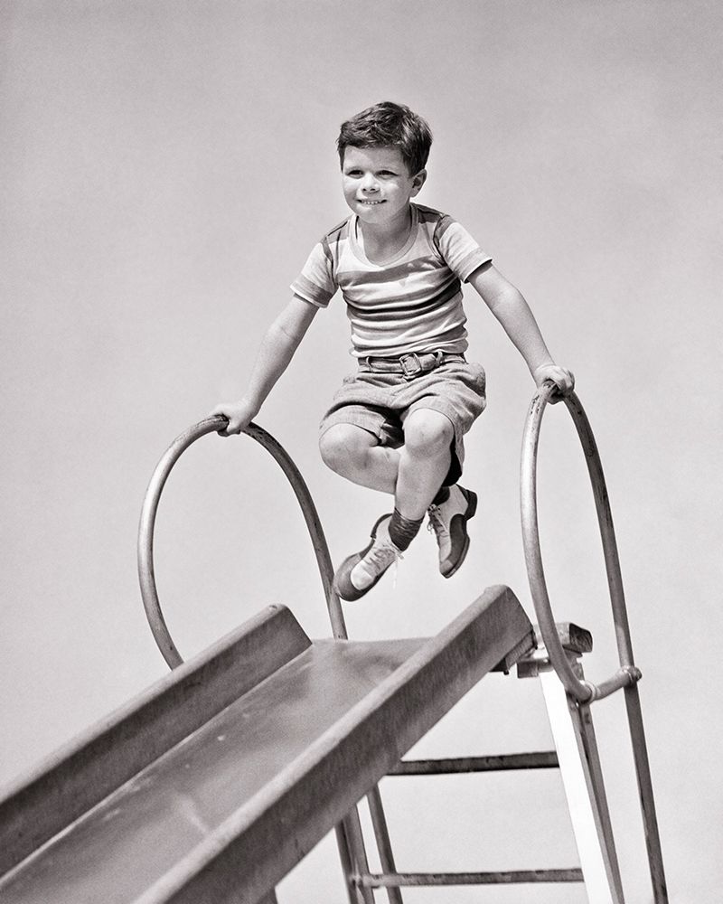 1940S Boy At Top Of Playground Slide Pushing Up On Hand Rails Crossing His Legs Funny Expression art print by H. Armstrong Roberts for $57.95 CAD