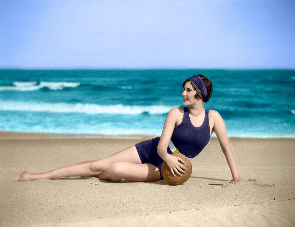 1920S Woman In Bathing Suit Stretched Out On Beach In Front Of Water Holding Ball art print by ClassicStock for $57.95 CAD