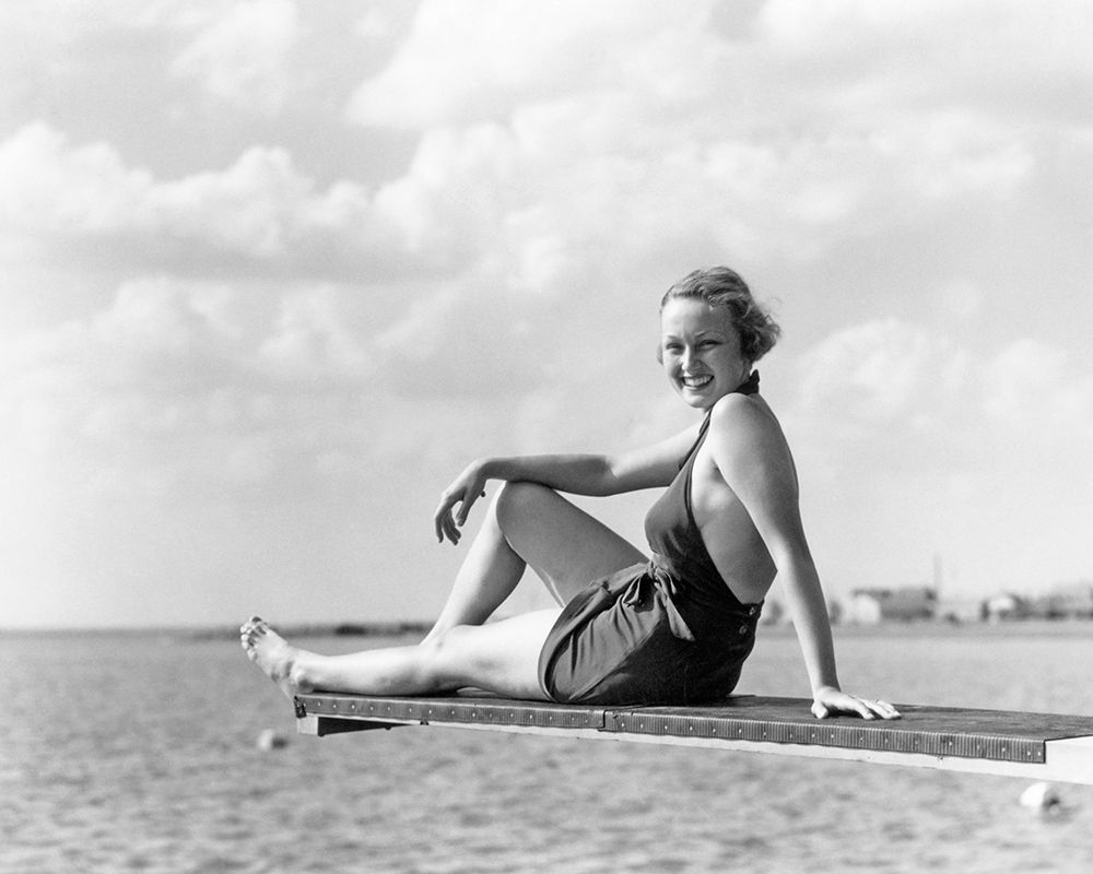 1930S Smiling Woman In Bathing Suit Sitting On Edge Of Diving Board Over Water Looking At Camera art print by ClassicStock for $57.95 CAD