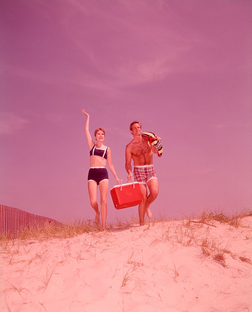 1960S Beach Couple Walking In Sand Carrying Cooler Woman Waving art print by ClassicStock for $57.95 CAD