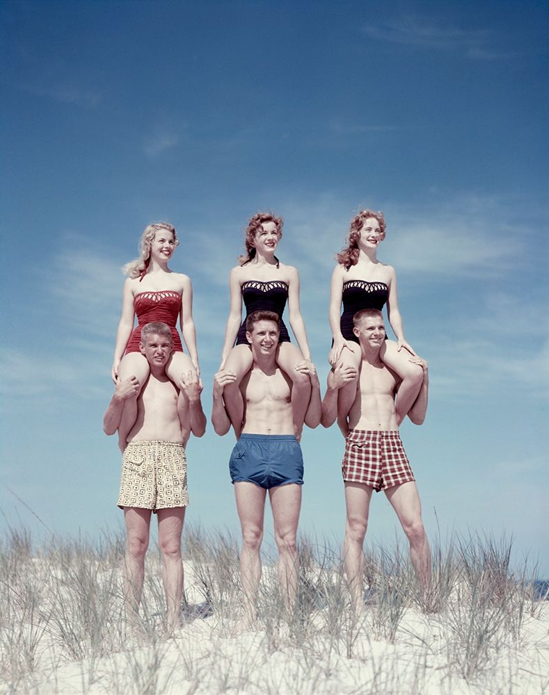 1950S Three Teenage Couples Standing On Sand Dune Girls Sitting On Guys Shoulders art print by ClassicStock for $57.95 CAD