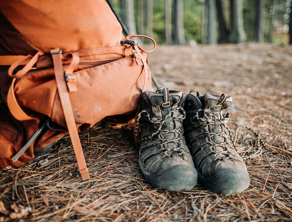 A Detail Of A Pack And Hiking Boots On A Forest Floor In The Woods art print by Chris Bennett for $57.95 CAD
