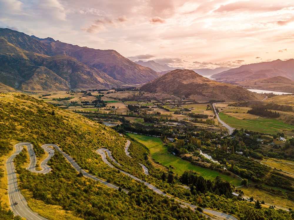 Drone Shot Of Curvy Road In Valley In New Zealand art print by Alex Lustig for $57.95 CAD