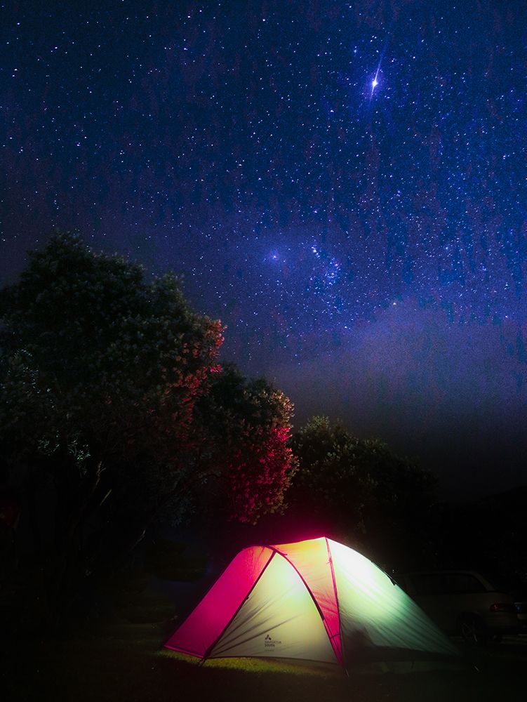 Lit Up Tent With A Starry Night Sky In New Zealand art print by Alex Lustig for $57.95 CAD