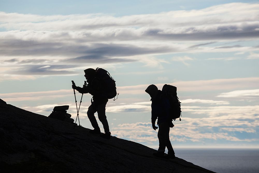 Hikers Ascend A Ridge Above Sorvagen, Moskenesoya, Lofoten Islands, Norway. art print by Ethan Welty for $57.95 CAD
