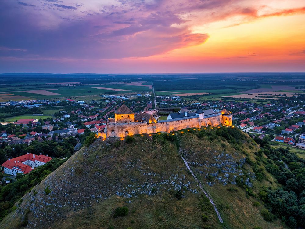 Sumeg Castle Drone View Illuminating At Sunset In Hungary art print by Luis Pina for $57.95 CAD
