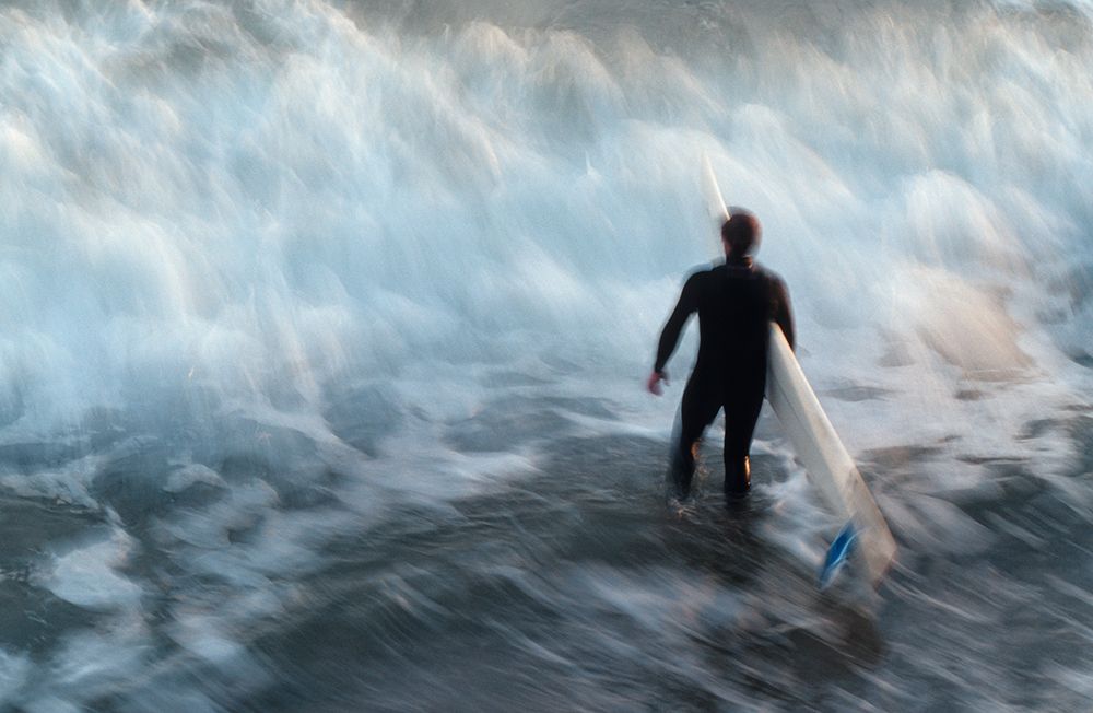 A Surfer Wades Into A Wave In Santa Barbara, California. (Blurred Motion) art print by Jonathan Kingston for $57.95 CAD