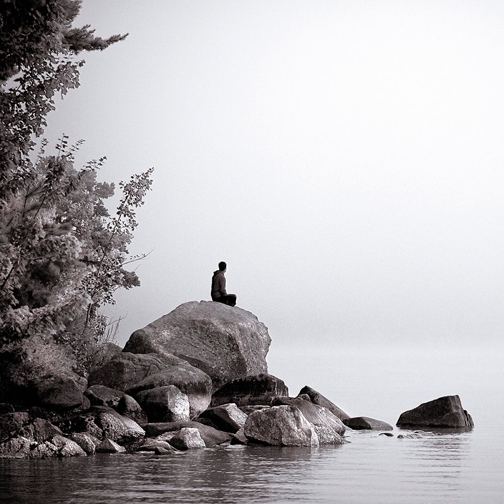 Young Man Sits On A Large Rock On The Shore Of Lake Sebago Near Portland, Maine (Black And White) art print by Kevin Steele for $57.95 CAD