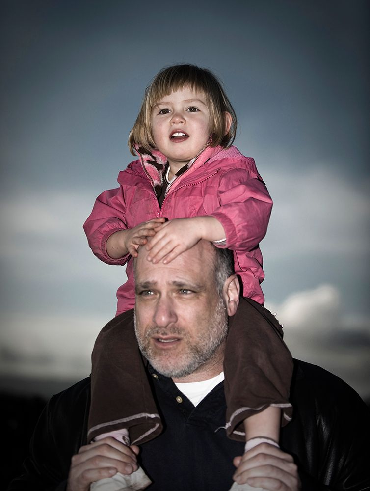 Portrait Of A Young Girl At Dusk On Her Fathers Shoulders. art print by Kevin Steele for $57.95 CAD
