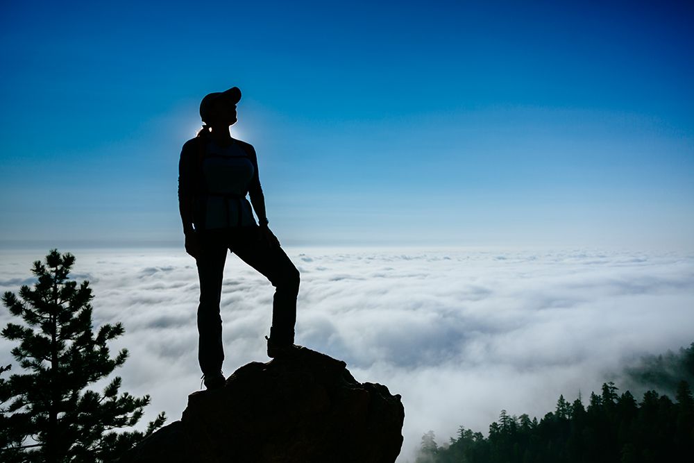 Silhouette Of A Woman Standing On Boulder In Colorado, USA art print by Andrew Peacock for $57.95 CAD