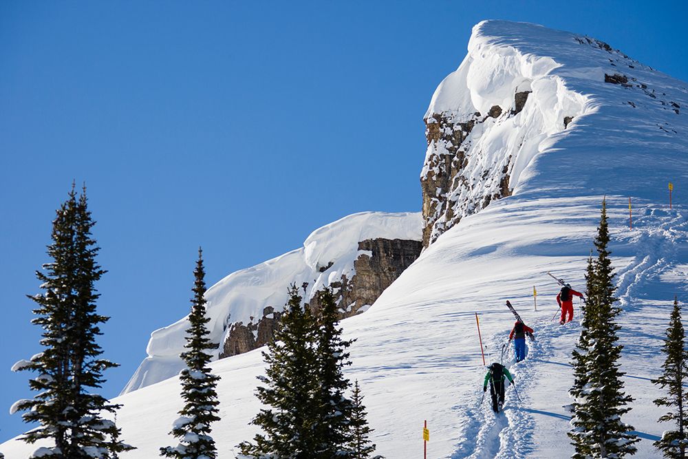 Group Of Three Skiers Hiking Up Boundary Line At Ski Area. art print by Gabe Rogel for $57.95 CAD