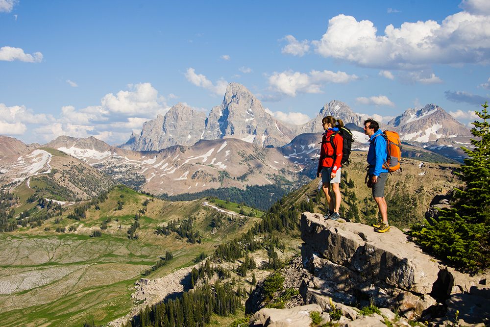 Man And Woman Hiking Looking Down At Valley. art print by Gabe Rogel for $57.95 CAD