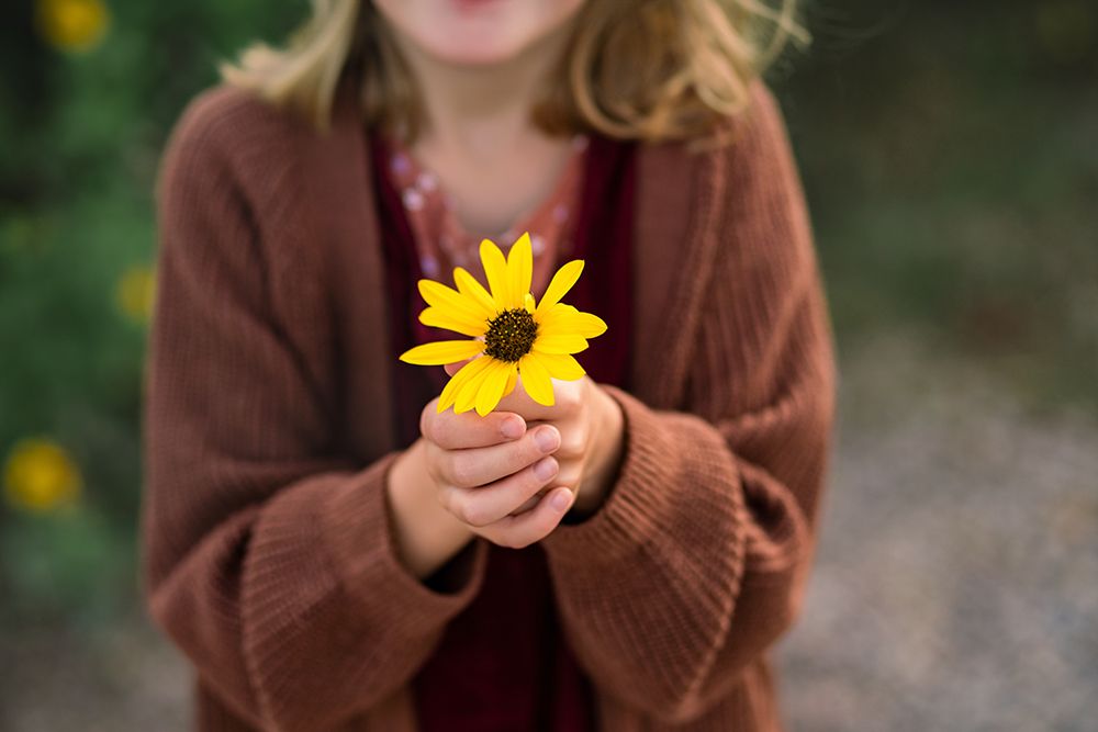 Faceless Child Holds Yellow Wildflower In Outstretched Hands Outdoors art print by Missy Mayo Photography for $57.95 CAD