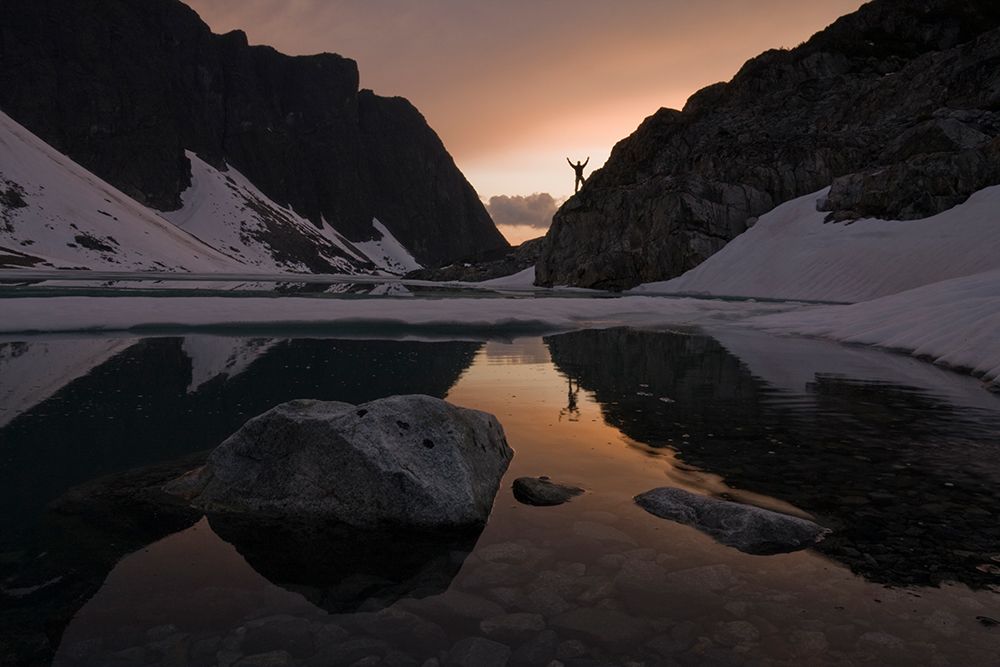 A Man Is Reflected At Sunset In Wedgemount Lake, Garibaldi Provincial Park, Canada. art print by Ethan Welty for $57.95 CAD