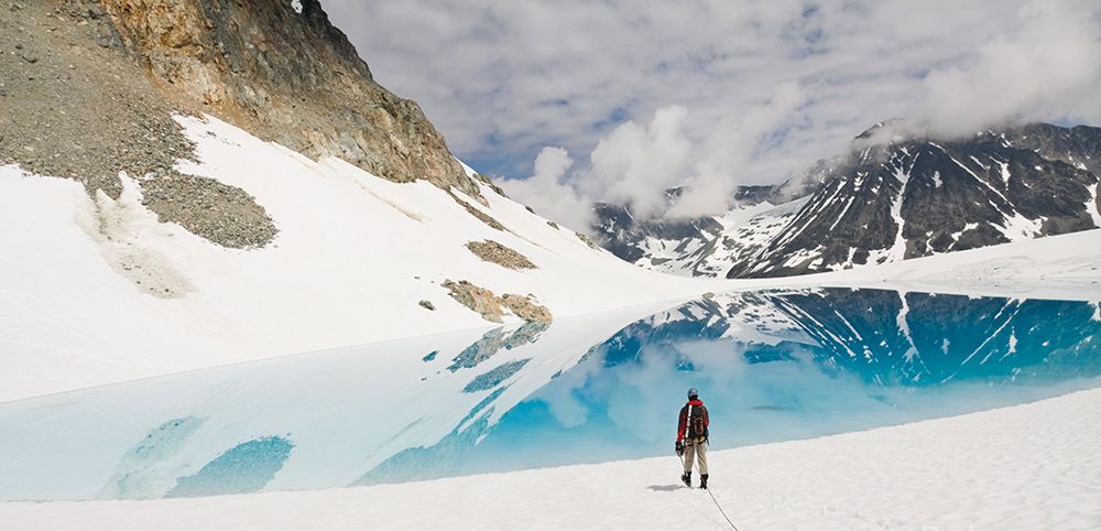 A Climber Approaches A Blue Lake On Wedgemount Glacier In Garibaldi Provincial Park art print by Ethan Welty for $57.95 CAD