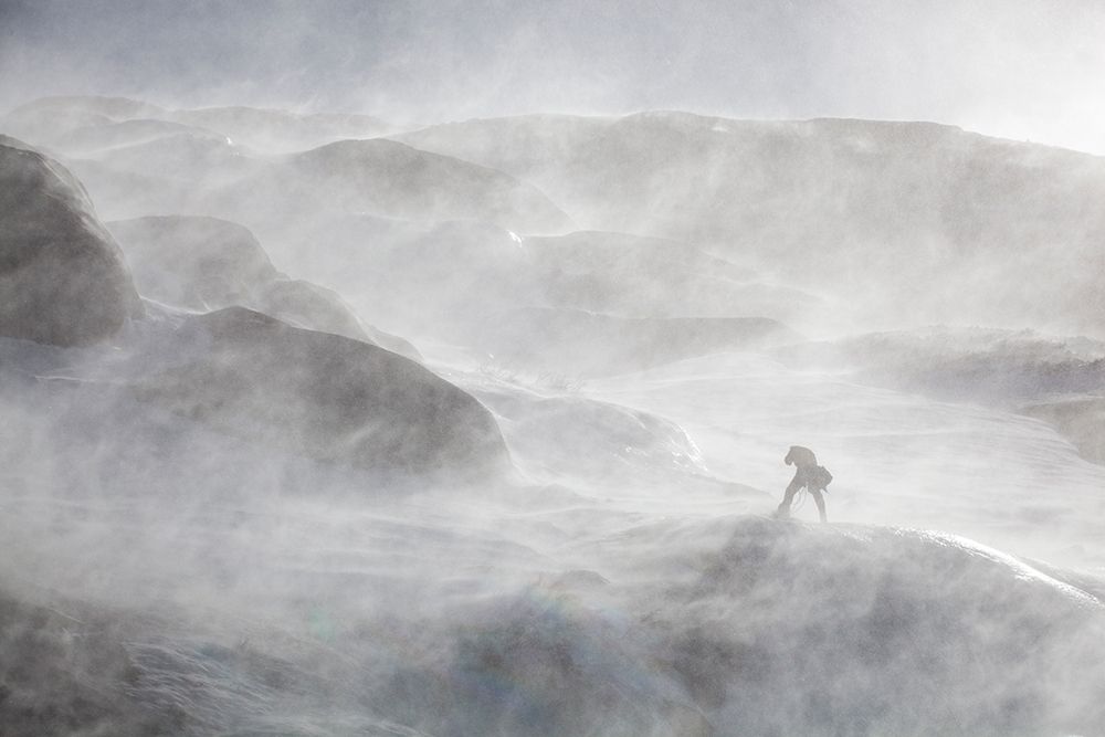 Ice Climber Is Surrounded By Blowing Snow On Cliff Above Black Lake, Rocky Mountain Colorado. art print by Ethan Welty for $57.95 CAD