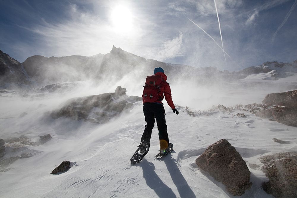 Hiker Is Surrounded By Blowing Snow In Alpine Basin Above Black Lake In Rocky Mountain Colorado. art print by Ethan Welty for $57.95 CAD
