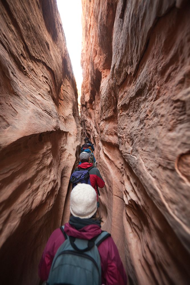 Hikers Squeeze Up The Narrow Little Wild Horse Canyon, San Rafael Swell, Utah. art print by Ethan Welty for $57.95 CAD