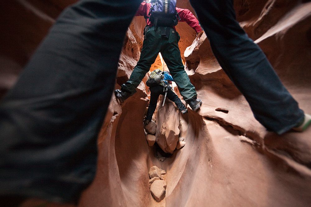Hikers Squeeze Up The Narrow Little Wild Horse Canyon, San Rafael Swell, Utah. art print by Ethan Welty for $57.95 CAD