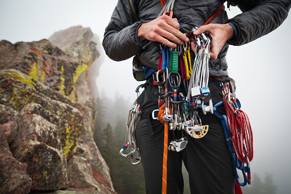 A Young Man Sorts Nuts And Cams On A Climb Of The First Flatiron Above Boulder, Colorado. art print by Ethan Welty for $57.95 CAD