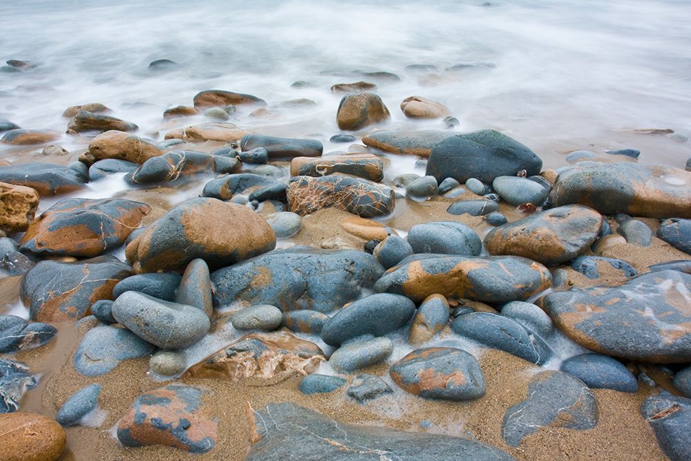 Waves Swirl Over Colorful Rounded Rocks On The Rocky Shore Of Pescadero State Beach, California. art print by Ethan Welty for $57.95 CAD