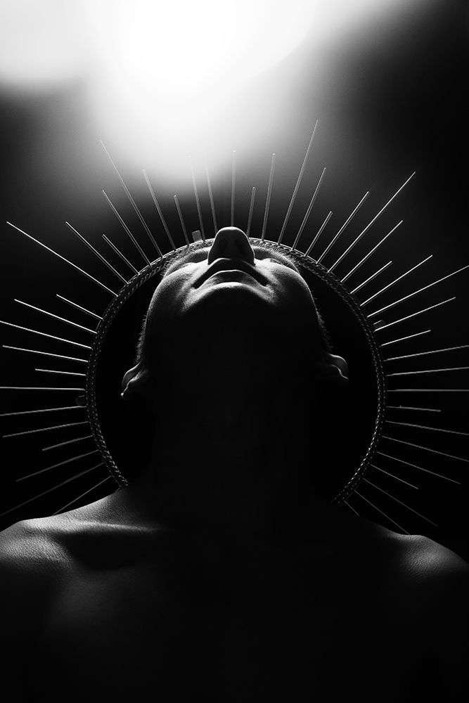 Person With Radiant Headpiece Looking Upwards In Black And White art print by diczman for $57.95 CAD