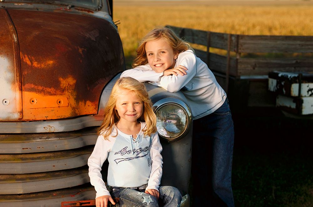 Two Young Sisters Pose For A Portrait At Home In Lone Tree, Iowa. art print by Earl Harper for $57.95 CAD