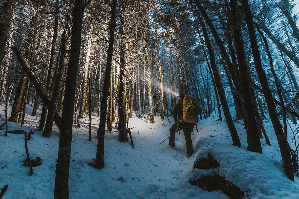 Man With Backpack Hikes Through Wintery Woods In Snow, New Hampshire art print by Chris Bennett for $57.95 CAD