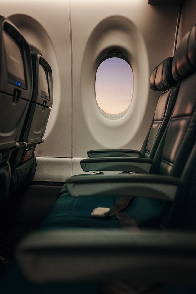 Soft Light Falls Across Empty Airplane Seats At The Window. art print by Tyler Rickenbach for $57.95 CAD