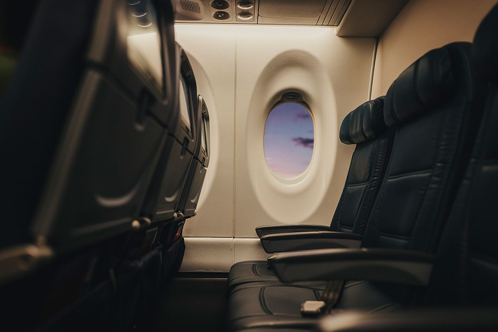 Soft Light Falls Across Empty Airplane Seats At The Window. art print by Tyler Rickenbach for $57.95 CAD