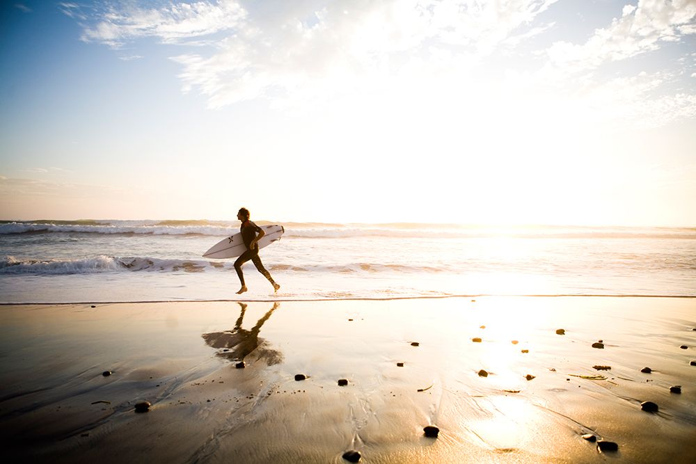 A Surfer Run Across The Beach Landscape In Carlsbad, Ca. art print by Jay Reilly for $57.95 CAD