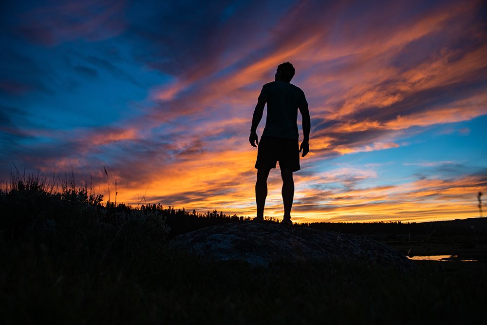 Explore The Serenity Of Nature: Silhouette Of A Man Embracing A Stunning Sunset Landscape art print by Max Seigal for $57.95 CAD