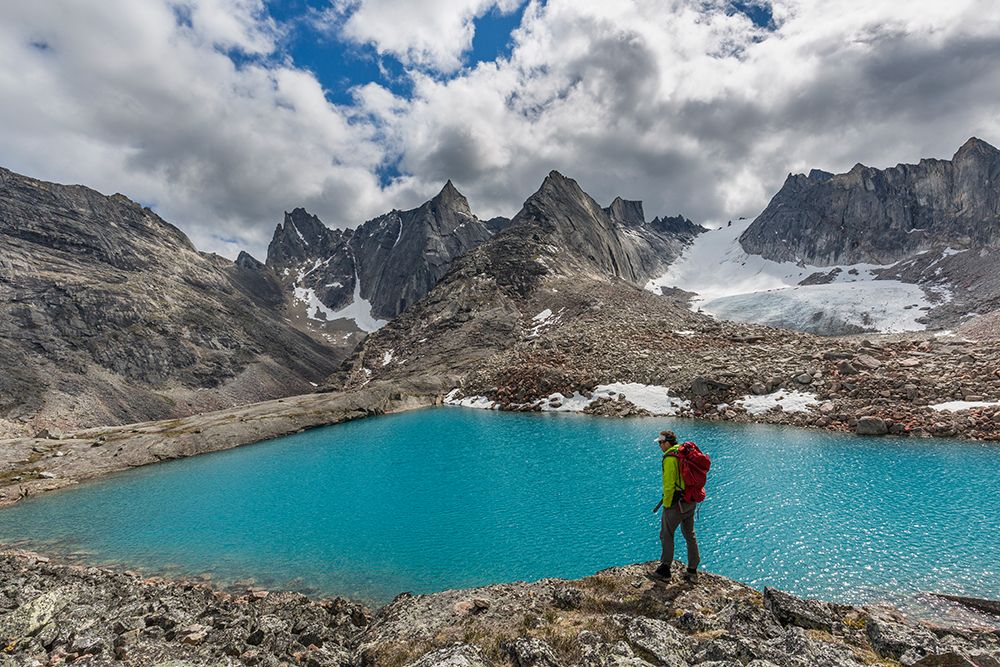 Man Pauses While Hiking At Edge Of Blue Lake In Arrigetch Peaks, Valley Of Aquarius, Gates Of Alaska art print by Patrick J Endres for $57.95 CAD