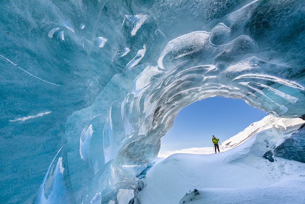Man On Cross Country Skis Peers Into Entrance Of Glacier Ice Cave In Alaska Range, Interior, Alaska. art print by Patrick J Endres for $57.95 CAD