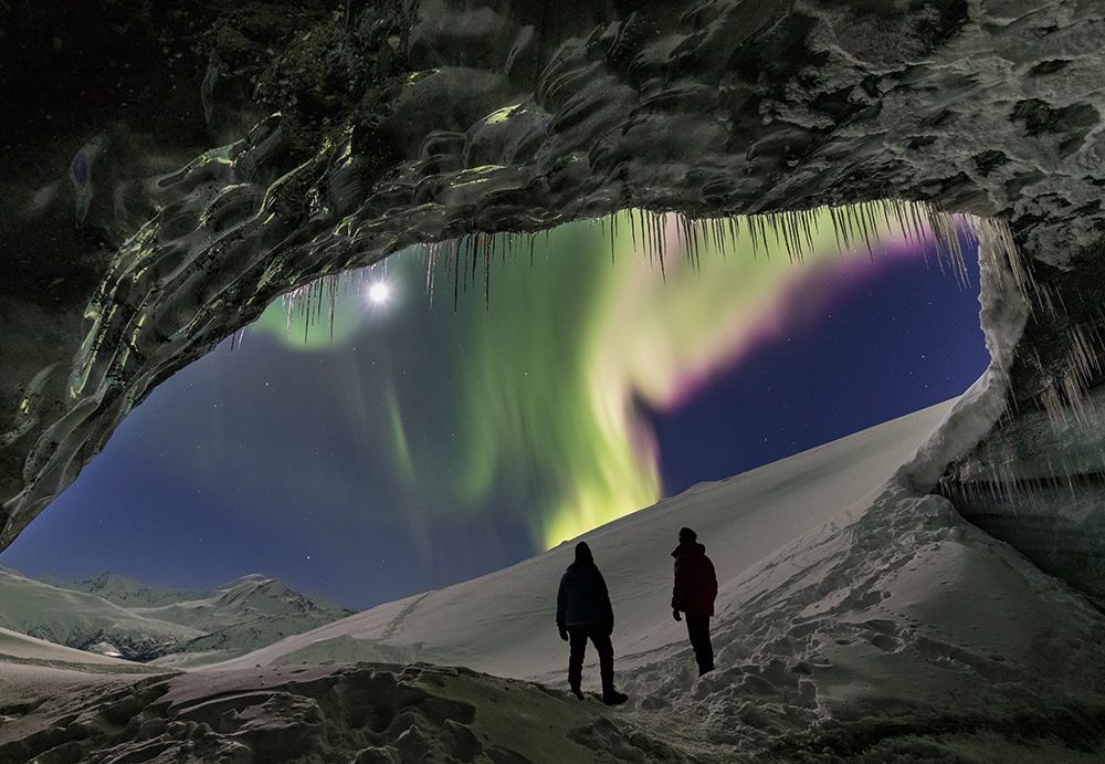 Two People Watch Northern Lights From Entrance Of An Ice Cave In The Alaska Range, Interior, Alaska. art print by Patrick J Endres for $57.95 CAD