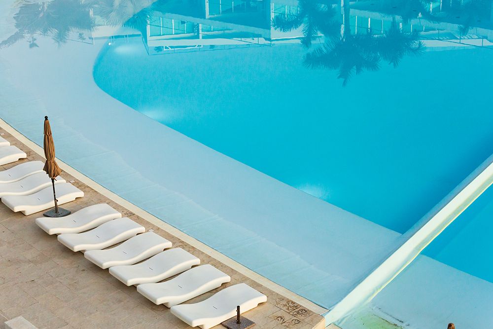 Mexico, Nayarit, Bucerias. Poolside Chaise Lounges And Reflections In A Swimming Pool. art print by Emily M Wilson for $57.95 CAD