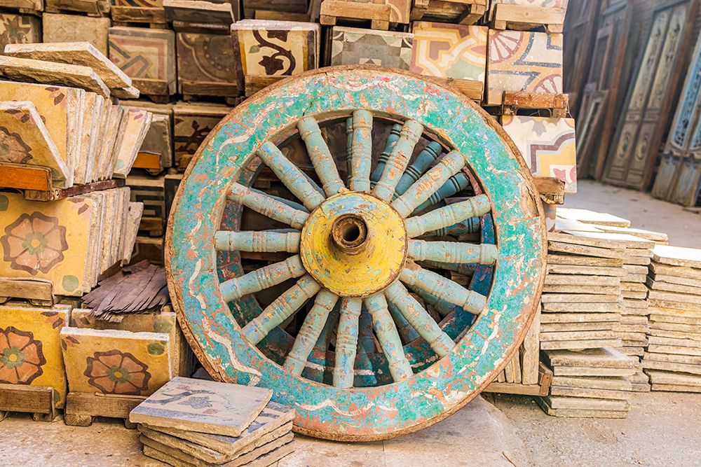 Old Cairo-Cairo-Egypt Wooden cart wheel and floor tiles in an alley in Cairo art print by Emily M. Wilson for $57.95 CAD
