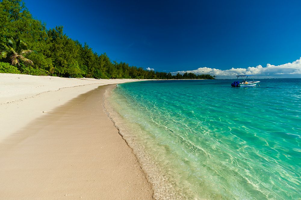 A boat anchored off the shore of a pristine tropical beach Denis Island-Seychelles art print by Sergio Pitamitz for $57.95 CAD